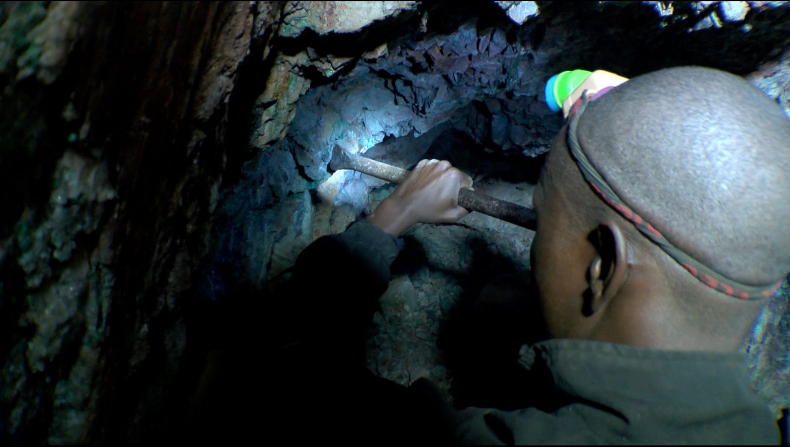 Émile carving the rock in the search of copper.